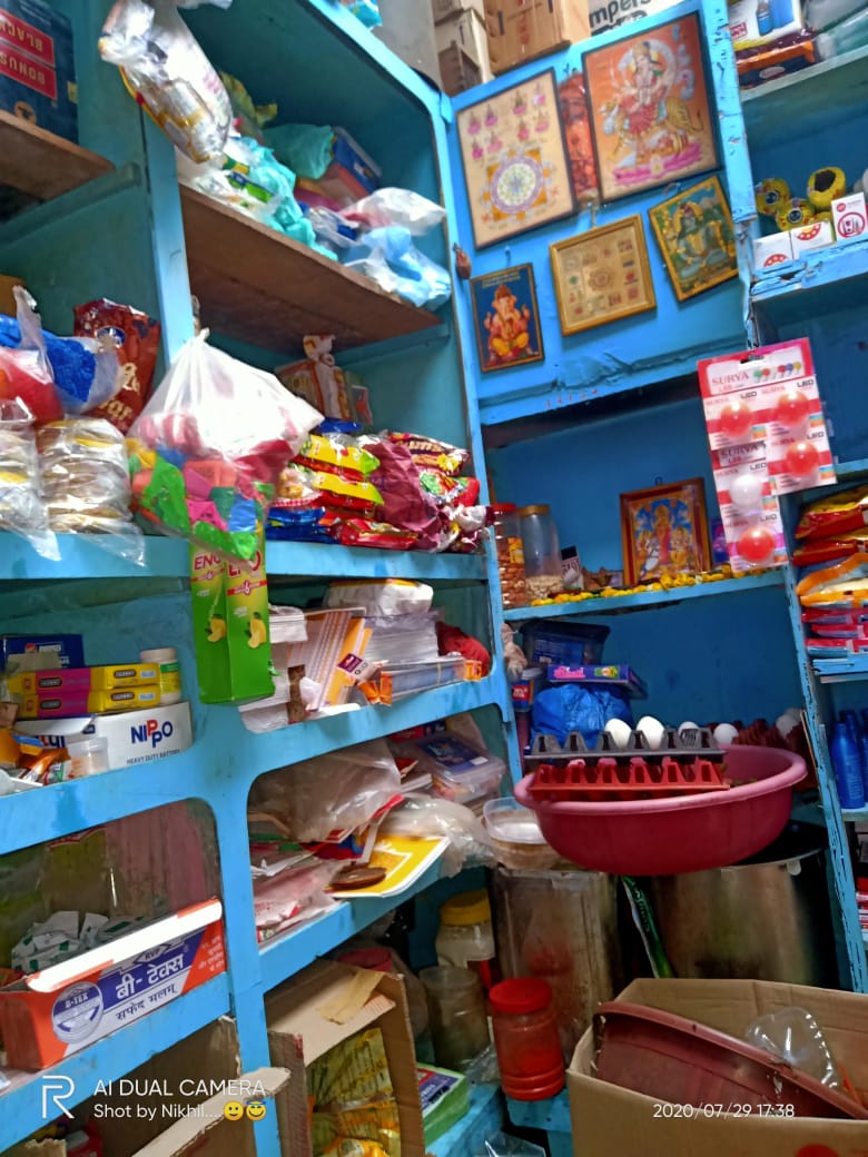 Checkout area with grocery products on display and a friendly small store ambience